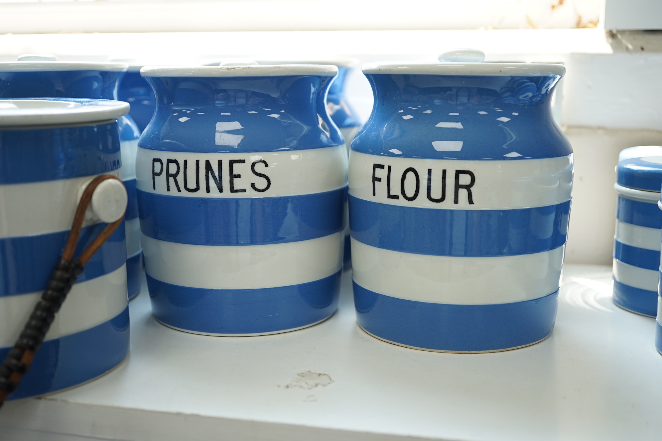 T.G.Green Cornish Kitchenware, seven 14cm lidded storage jars to include Vermicelli, Macaroni, Treacle, Biscuits and Prunes with a smaller Biscuit jar and cover, mainly Green Church marks. Condition - poor, fair and good